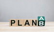 © Midnight Studio - Rows of wooden cubes change from Plan A to Plan B on a wooden table. Concept of planning, contingency plans and risk management with backup plans.