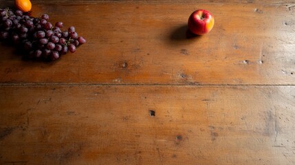 Aufkleber - A vibrant red apple stands out on a rustic wooden table, surrounded by fresh grapes and oranges, illuminated by soft natural light from the side