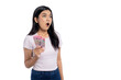 © Sewupari Studio - Surprised young Asian woman holding Indonesian rupiah cash, looking amazed, isolated on transparent background