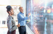 © Westend61 - Two professionals collaborating on a digital screen with augmented reality in an office setting