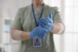 © New Africa - Medical worker putting on gloves in hospital, closeup