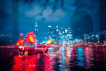 Poster - Night scene of Hong Kong uses double exposure, blending a traditional junk boat with the city's illuminated skyline reflecting on dark water.