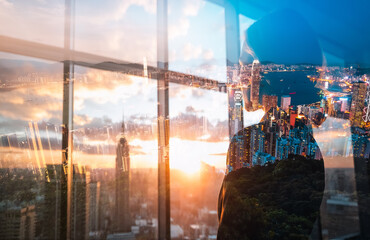 Poster - Double exposure view of Hong Kong cityscape at sunset from a high vantage point. Urban skyline and sky are beautifully blended together.