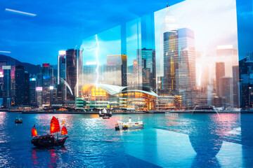 Poster - Hong Kong cityscape with a double exposure effect, blending modern architecture with traditional boats on the water under a twilight sky.