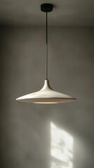 Poster - A beautifully designed pendant light hangs from the ceiling, illuminating a tranquil gray space. The gentle glow creates a cozy atmosphere, perfect for relaxation