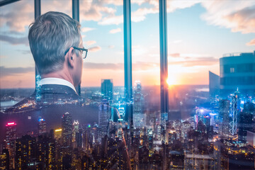 Poster - Double exposure of man in suit looking at Hong Kong cityscape at dusk through window.
