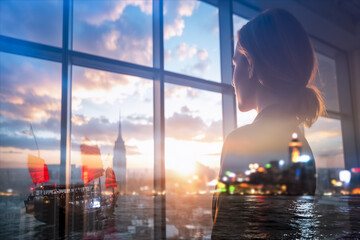 Poster - A woman gazes out a window with a double exposure effect, blending her silhouette with the skyline of Hong Kong at sunset, featuring a traditional junk boat sailing on the water.