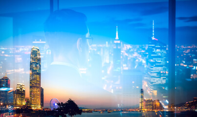 Poster - A double exposure captures the Hong Kong skyline at night with vibrant city lights. A silhouette of a person appears layered over the urban landscape.