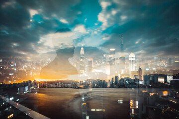 Poster - Double exposure of Hong Kong skyline blends with a silhouette against a dramatic sky at twilight. City lights glow beneath the cloudy expanse.