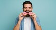 © Gofox - Happy man enjoying two frosted donuts.