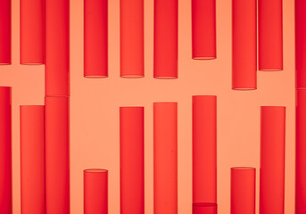 Poster - Red test tubes pattern background shows many test tubes of different lengths arranged in a repeating pattern against a red backdrop creating an abstract design