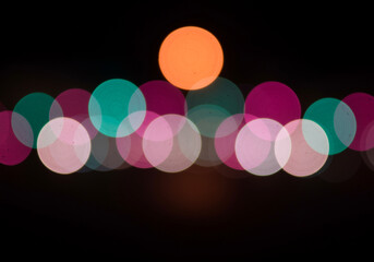 Poster - Abstract bokeh lights background with colorful bokeh circles in orange teal and magenta hues creating a blurred and dreamy effect with soft glow