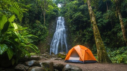 Poster - Orange tent pitched near a lush waterfall in a tropical rainforest.