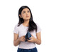 © Sewupari Studio - Worried young Asian woman looking up while holding an empty wallet, thinking about financial problems, isolated on transparent background