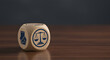 © Creative Creating - Wooden cube with legal and justice symbols, including scales of justice and contract signing, representing law, fairness, and decision-making concepts.