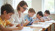 © Radorog. - the teacher is reading a book on a tablet, the children are writing students in a notebook, a lesson at school