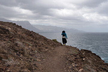 hiker walking along the north coast of gran canaria, canary islands.