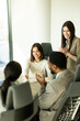 © BGStock72 - Professionals engage in a collaborative discussion during a bright office meeting