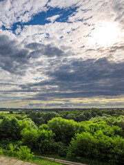 Wall Mural - a cloudy sky with a sun peeking through the clouds