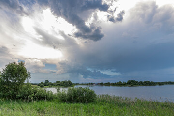 Wall Mural - a cloudy sky with a sun peeking through the clouds