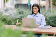 © Xavier Lorenzo - Young businesswoman eating healthy salad while working on laptop computer outside. Business lifestyle and freelancer people concept.