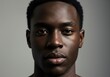 © Alper AI - A captivating portrait of a young black man, showcasing his striking features in a soft studio light.