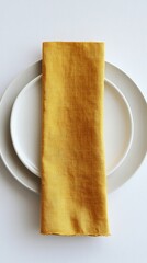 Poster - A beautifully arranged yellow linen napkin rests on a pristine white plate, showcasing the simplicity and elegance of table settings perfect for any special occasion or casual meal