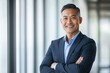 © Harry - Confident Successful Asian Businessman Portrait Professional Executive Smiling Happy Man Corporate Leader Wearing Suit Arms Crossed Modern Office