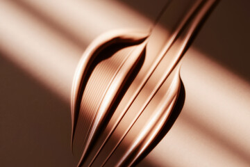 Poster - Sleek Metallic Waves in Warm Tones Illuminated by Soft Light