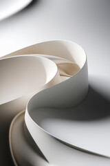 Poster - Elegant Curved White Ribbon Flowing Gracefully Across a Soft Gray Background