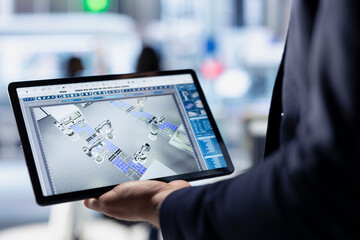Poster - technician using tablet to monitor solar panel plant assembly lines. close up of employee using touc