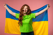 © kohanova1991 - Happy woman with national Ukrainian flag on pink. Ukraine, patriot, football fan