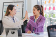 © Kritdanai - Successful Businesswomen High-Fiving in Office