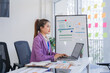 © Kritdanai - Asian Woman Working on Laptop in Modern Office