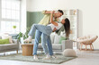 © Pixel-Shot - Happy young beautiful couple dancing at home