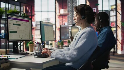 Poster - call center team of agents wearing headset assisting customers over phone at modern workstation with