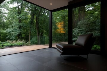 Poster - Modern Interior With Leather Armchair Overlooking Green Forest Through Large Windows During Daylight