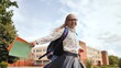 © Довидович Михаил - Schoolgirl running near campus, carrying notebooks, wearing backpack and glasses, embracing academic excitement