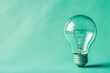© Atmospheric stock - Clear light bulb against turquoise background