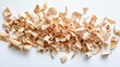 © Natchooda - A creative pile of natural wood shavings arranged on a white background, emphasizing the delicate texture and organic charm of the material.
