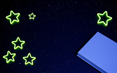 Wall Mural - glowing star shapes brightly shine against a dark blue night sky sprinkled with tiny dots, next to a