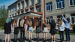 © Довидович Михаил - Happy students waving goodbye to high school on their last day, celebrating the end of the academic year