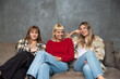 © Srdjan - Happy beautiful group of hipster millennial women meeting indoors and having fun. Young adult females best friends spending time together, concepts about domestic life, leisure and friendship.