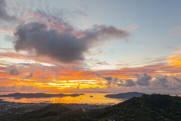 Wall Mural - aerial view bright sunrise above Chalong sea Phuket..beautiful cloud over archipelago..lens flare background.  4k stock footage video.