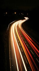 Poster - Dynamic light streaks illuminate a winding highway under a starless night sky creating a sense of speed and motion on the asphalt road
