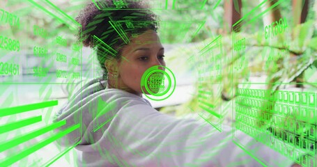 Poster - Interacting with futuristic green digital animation, woman focused on virtual screen