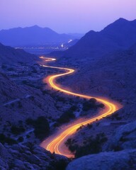 Poster - Serpentine road winding through a rugged mountain pass at twilight illuminating the landscape with vibrant light trails capturing the essence of adventure and travel