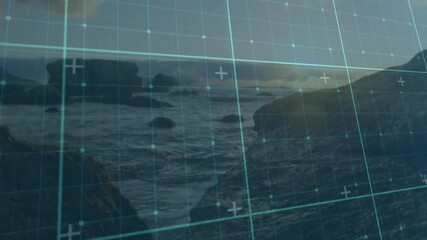 Poster - Digital grid overlaying rocky shoreline with ocean landscape in background