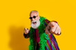 © deagreez - Photo of positive old showman point you cheerful have fun wear striped suit boa sunglass suit isolated yellow color background