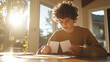 © FrameYesil - Focused teen studying with flashcards in a sunny room